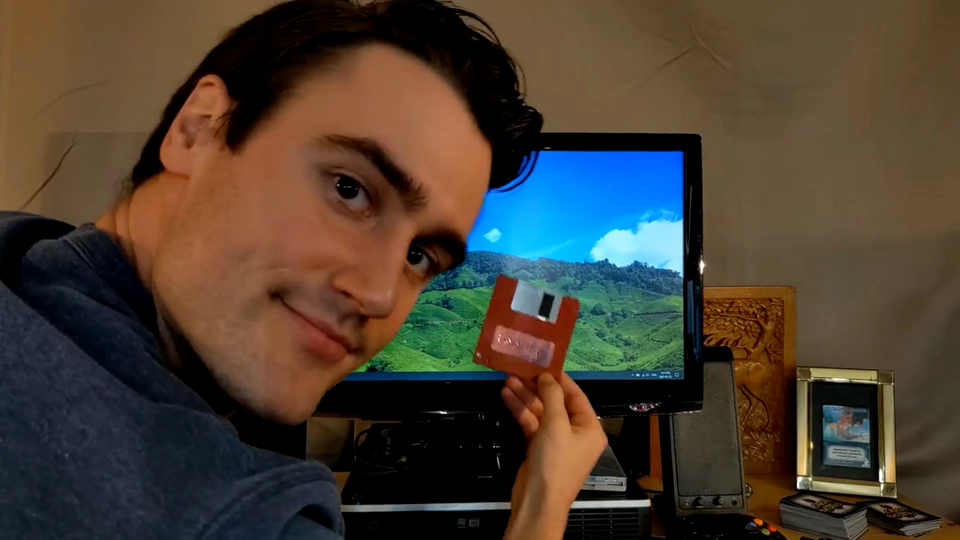 Luke Carder holding a floppy disk.