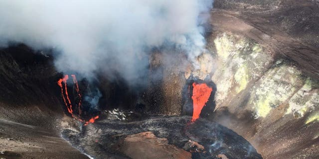 A plume rises near active fissures in the crater of Hawaii's Kilauea volcano on Monday, Dec. 21, 2020. People are lining up to try to get a look at the volcano on the Big Island, which erupted last night and spewed ash and steam into the atmosphere. A spokeswoman for Hawaii Volcanoes National Park says the volcanic activity is a risk to people in the park Monday and that caution is needed. (M. Patrick/U.S. Geological Survey via AP)