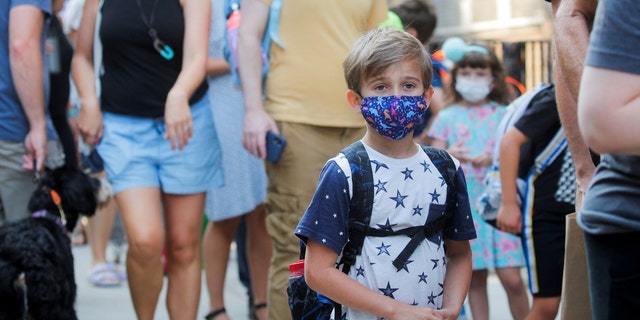 Children wear face masks on the first day of New York City schools last fall in this file photo.