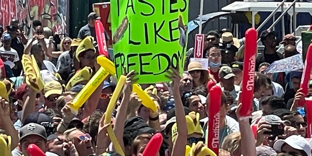 A person holds a sign that reads "Tastes like Freedom" during Nathan’s Famous Hot Dog Eating Contest at Coney Island on July 4, 2022.