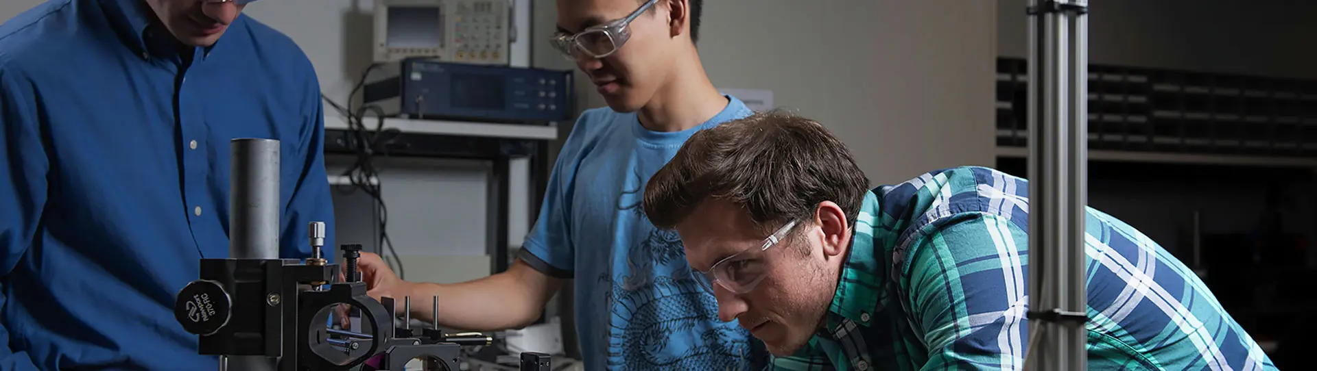 Smiling employee at LANL wearing protective glasses