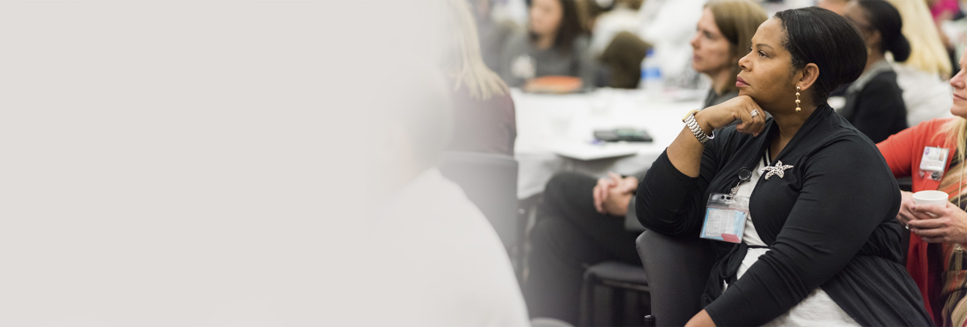 Staff member listening to a presentation with coworkers.