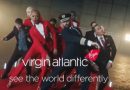 Two models in red Virgin Atlantic flight attendant uniform dresses. Photo: Virgin Atlantic.