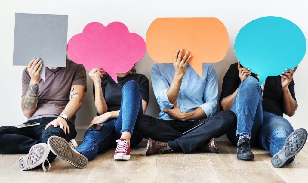 Group of diverse people with speech bubbles icons