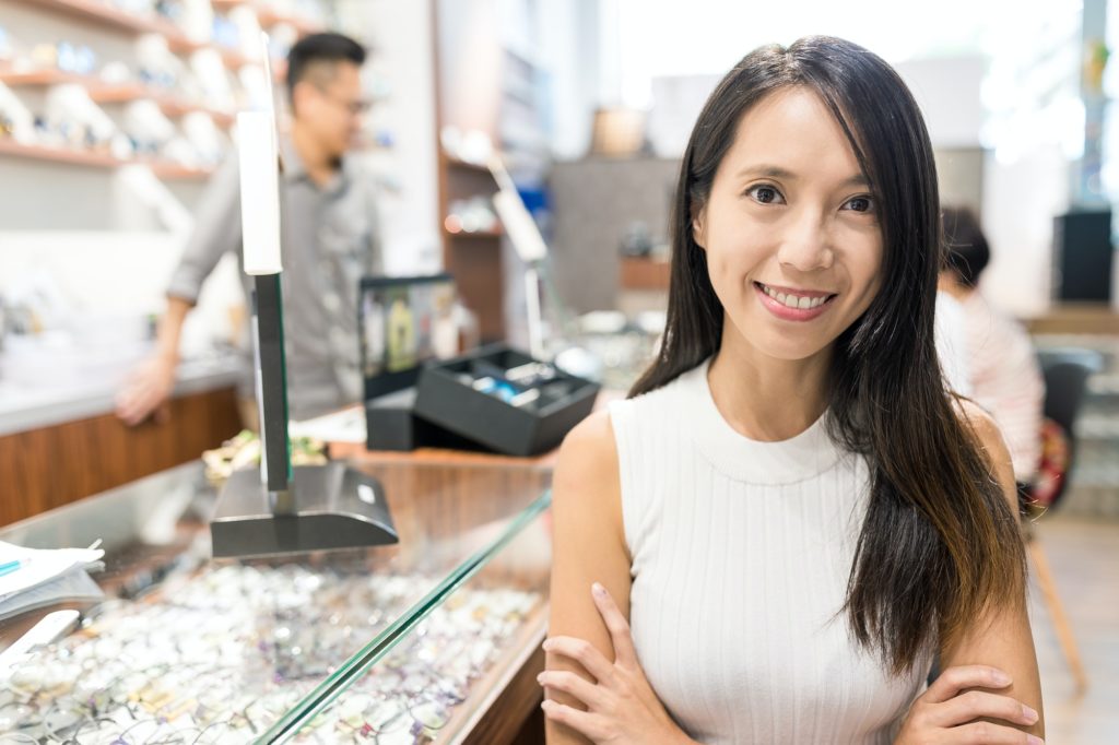 Woman holding small business in optical shop