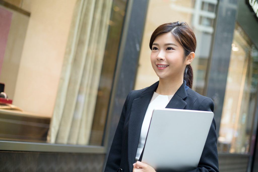 Business woman holding her personal laptop