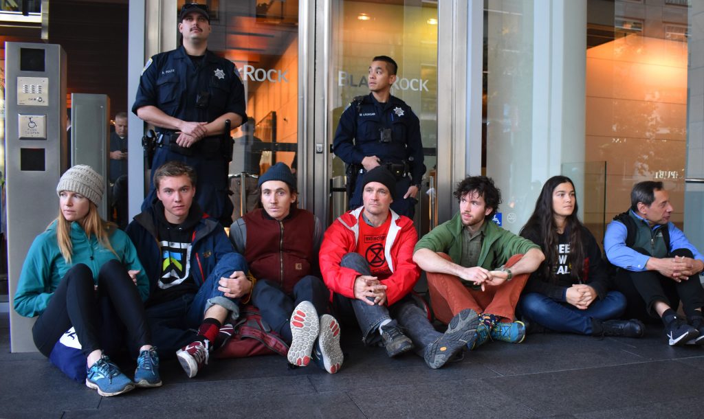 BHS senior Cedar Sklar-Luers (second from left) and climate activists block entrance to BlackRock's San Francisco offices on December 6.