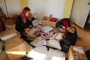Antifragile creators Macey Keung and Miumi Shipon work to package the first edition of their zine.