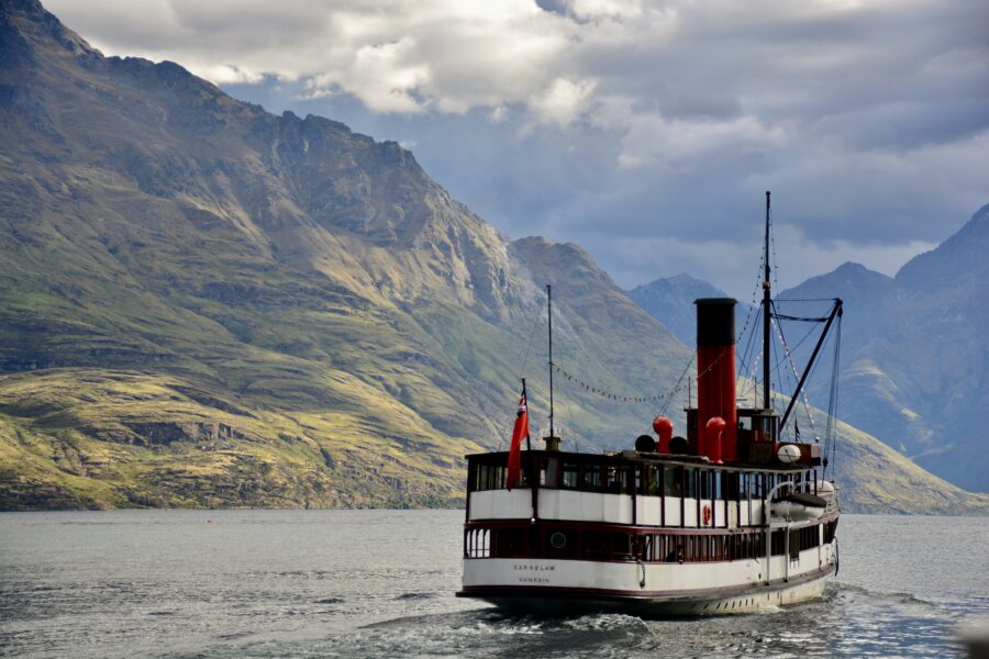 The TSS Earnslaw, the only remaining commercial passenger-carrying coal-fired steamship in the southern hemisphere, riding along Lake Wakatipu.