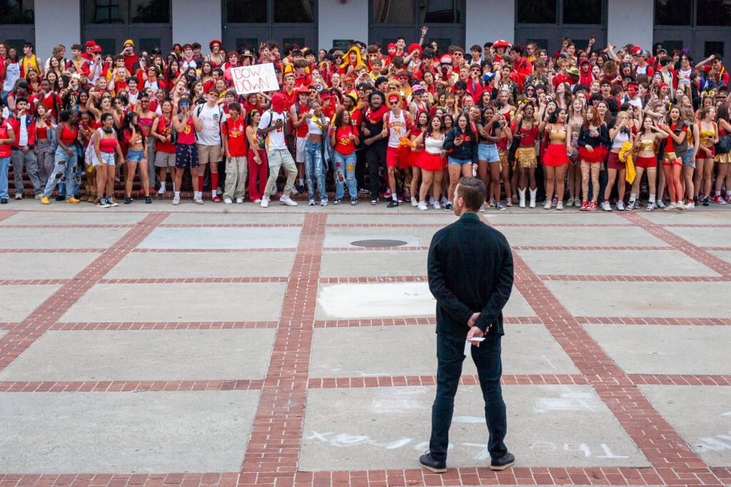 Chris Albeck stands in front of a crowd of students on Red and Gold Day.