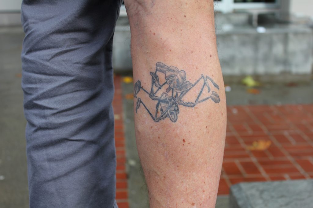 Philip Halpern shows off his monstera tattoo.