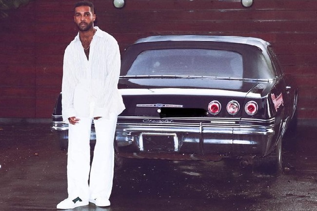 Lucien Laviscount poisng with his car (Source Instagram)