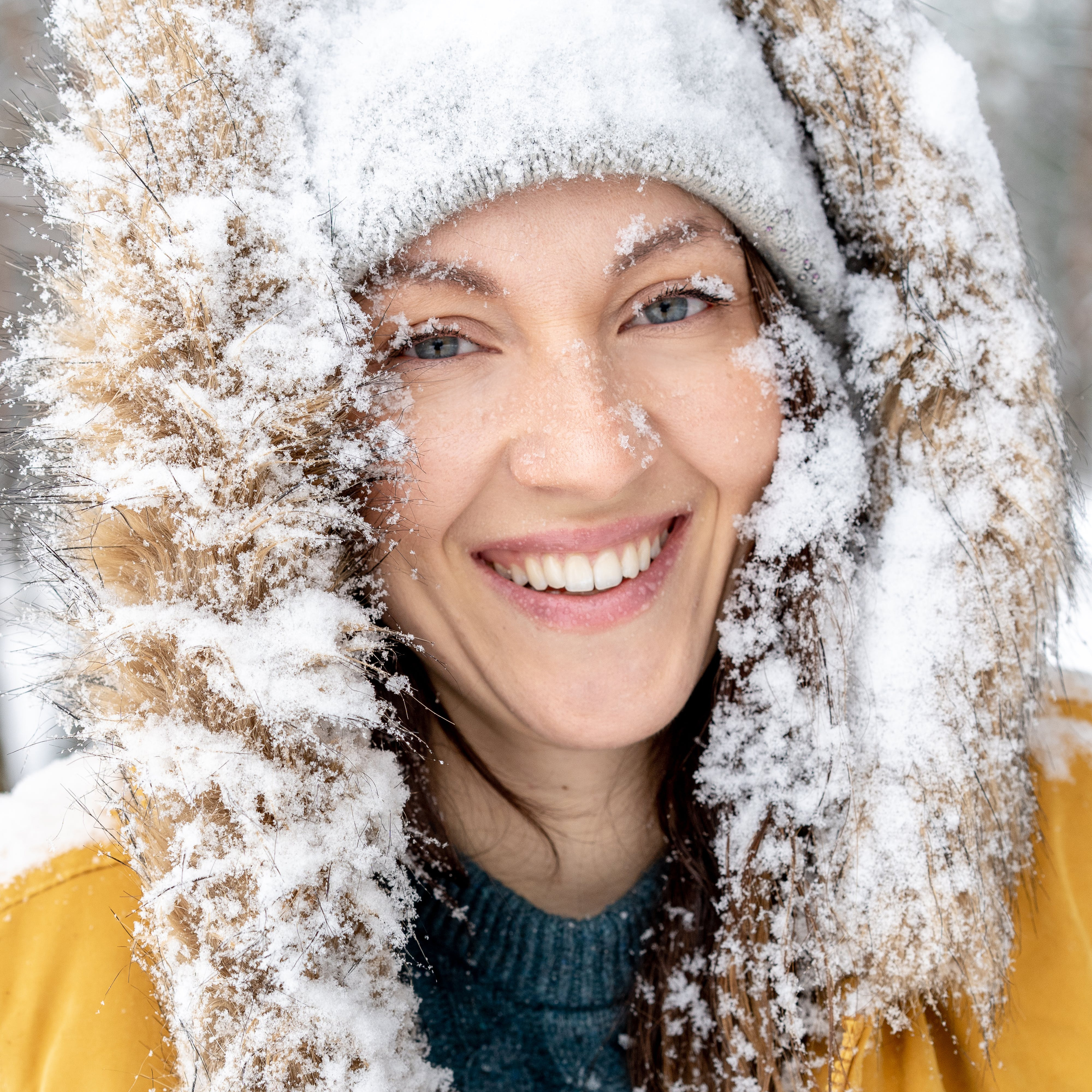 Photo of Smiling Woman Covered in Snow