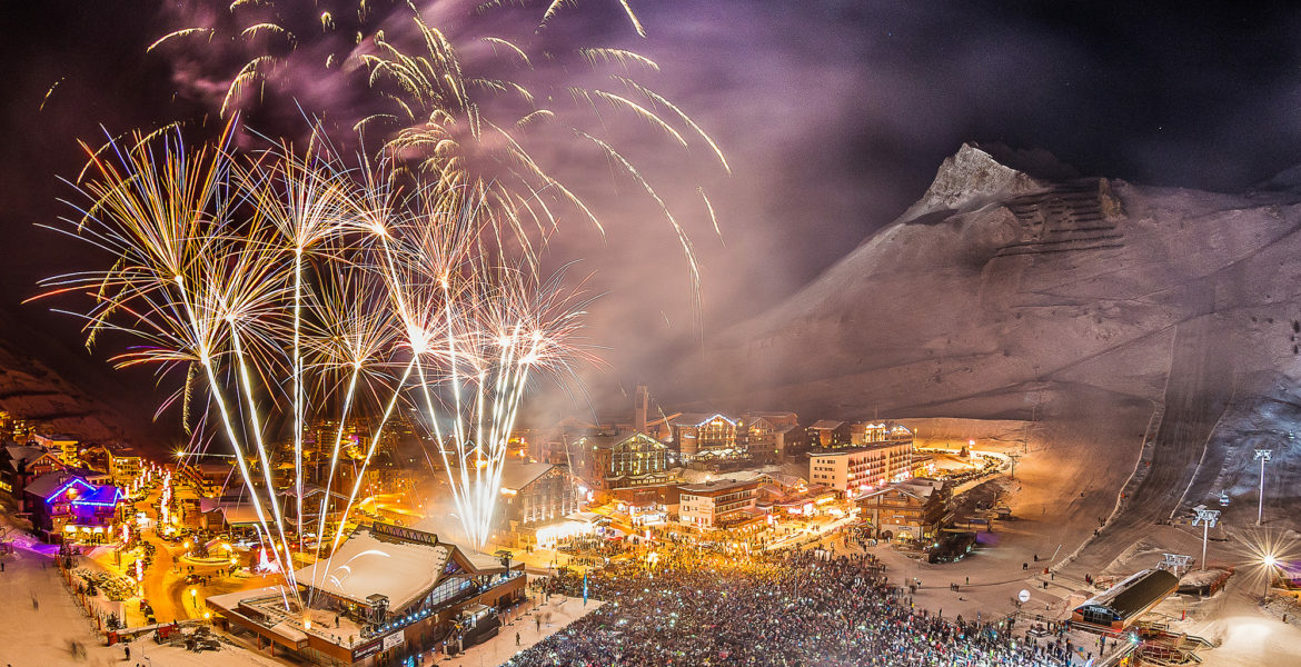 Huge fireworks display and large crowd on the snowfront of Tignes Le Lac for New Year's Eve