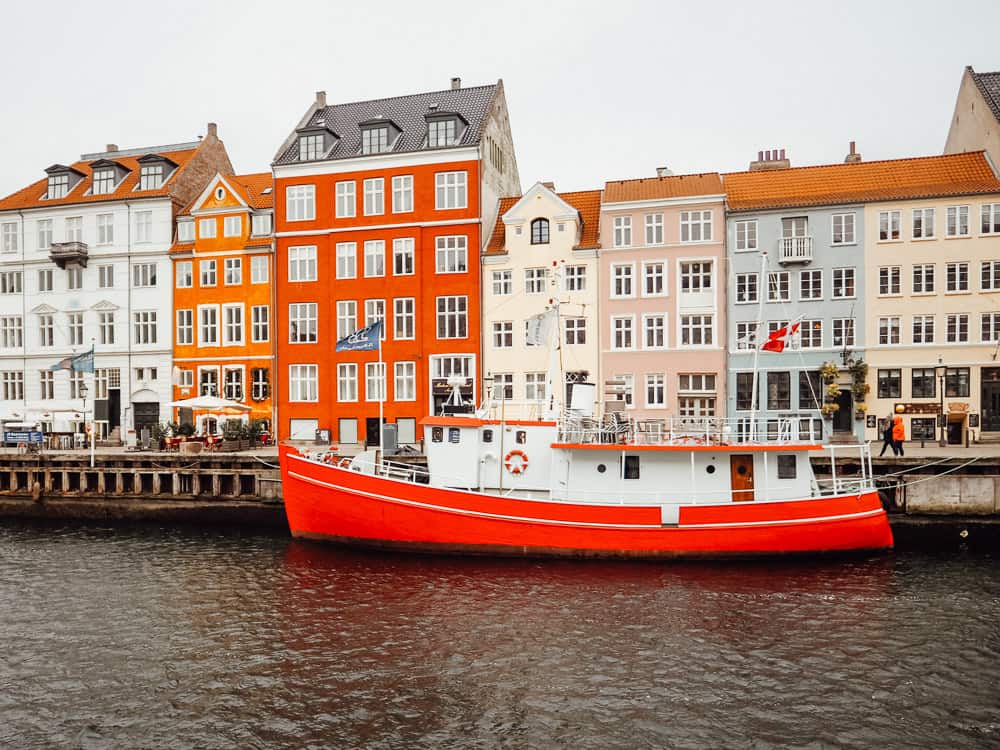 Red boat and colourful buildings at Nyhavn, Copenhagen