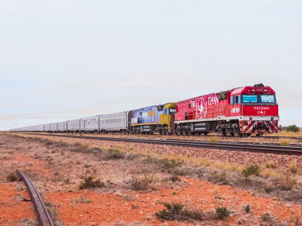 The iconic red diesel engine of the Ghan train parked in the desert at Coober Pedy