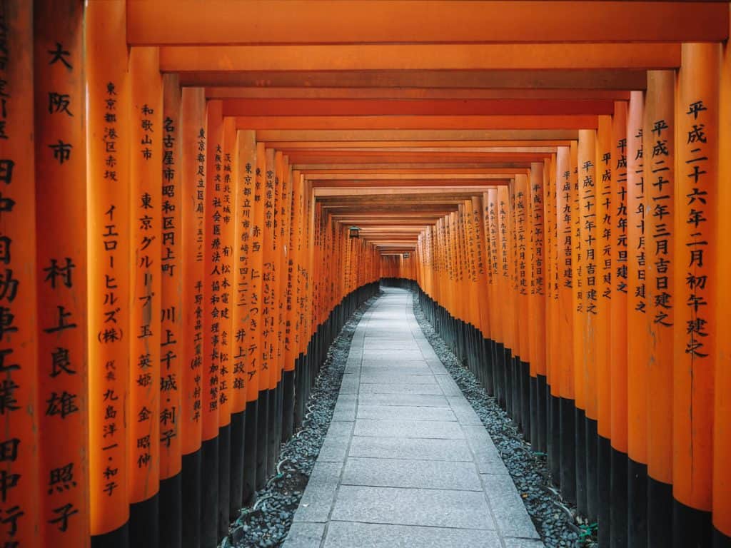 Views down the centre of the orange torii gates at Fushimi Inari shrine near Kyoto