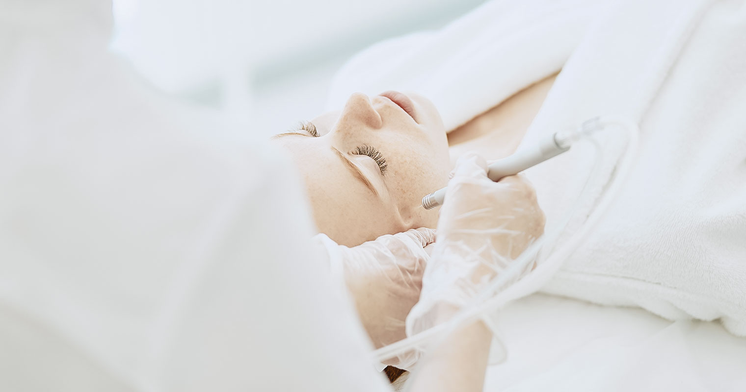Woman going through facial treatment