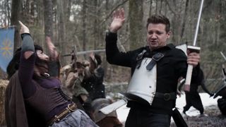Jeremy Renner as Clint Barton/Hawkeye, sword fighting at a Renaissance Faire in the Hawkeye show