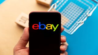 Image showing person holding a smartphone with eBay logo on the screen