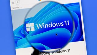 The Windows 11 logo seen through a digital magnifying glass 