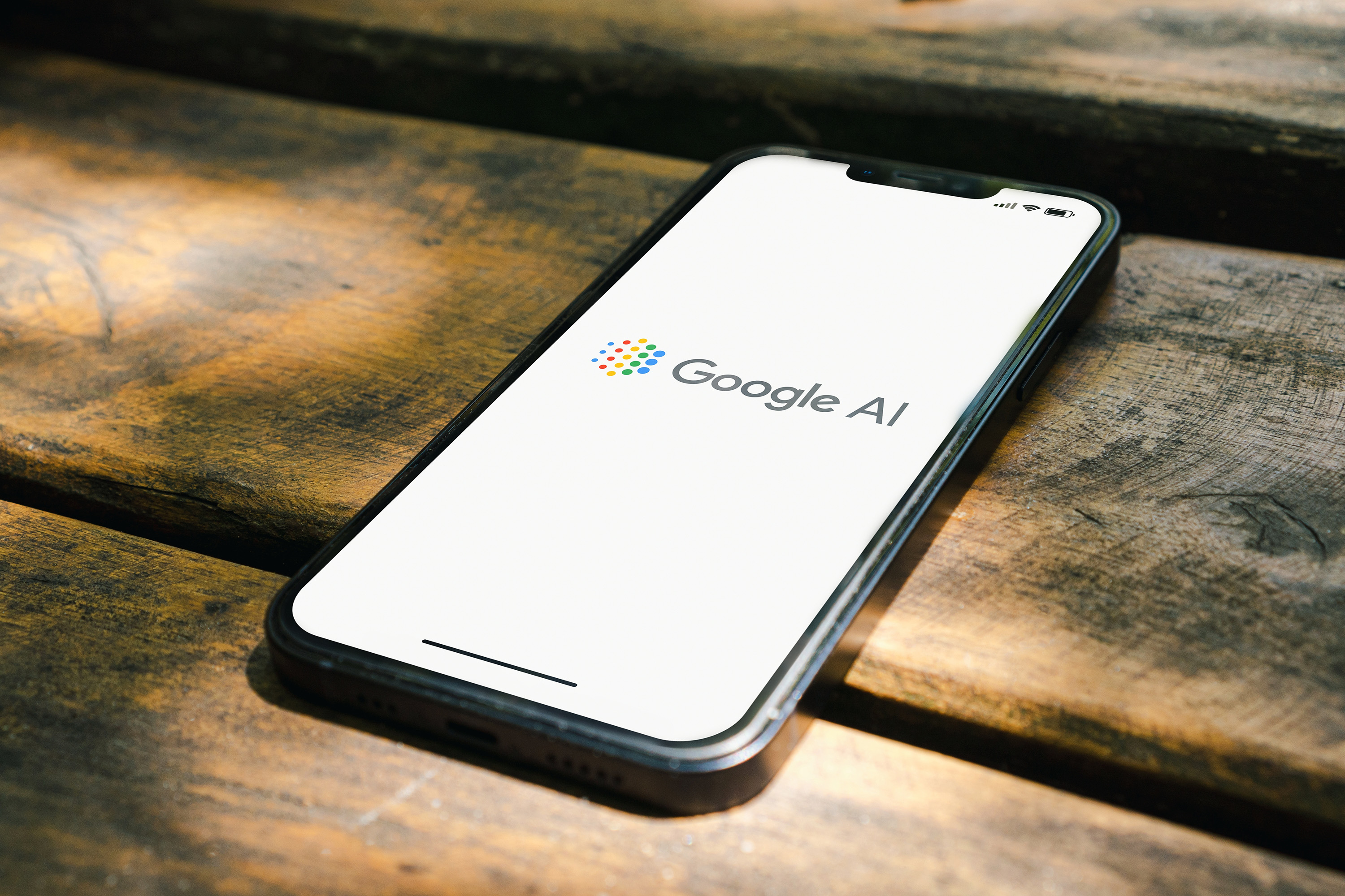 Google AI logo on phone laying on a table