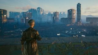 An image taken within Cyberpunk 2077's photo mode of the Night City skyline with a character stood in the lower left