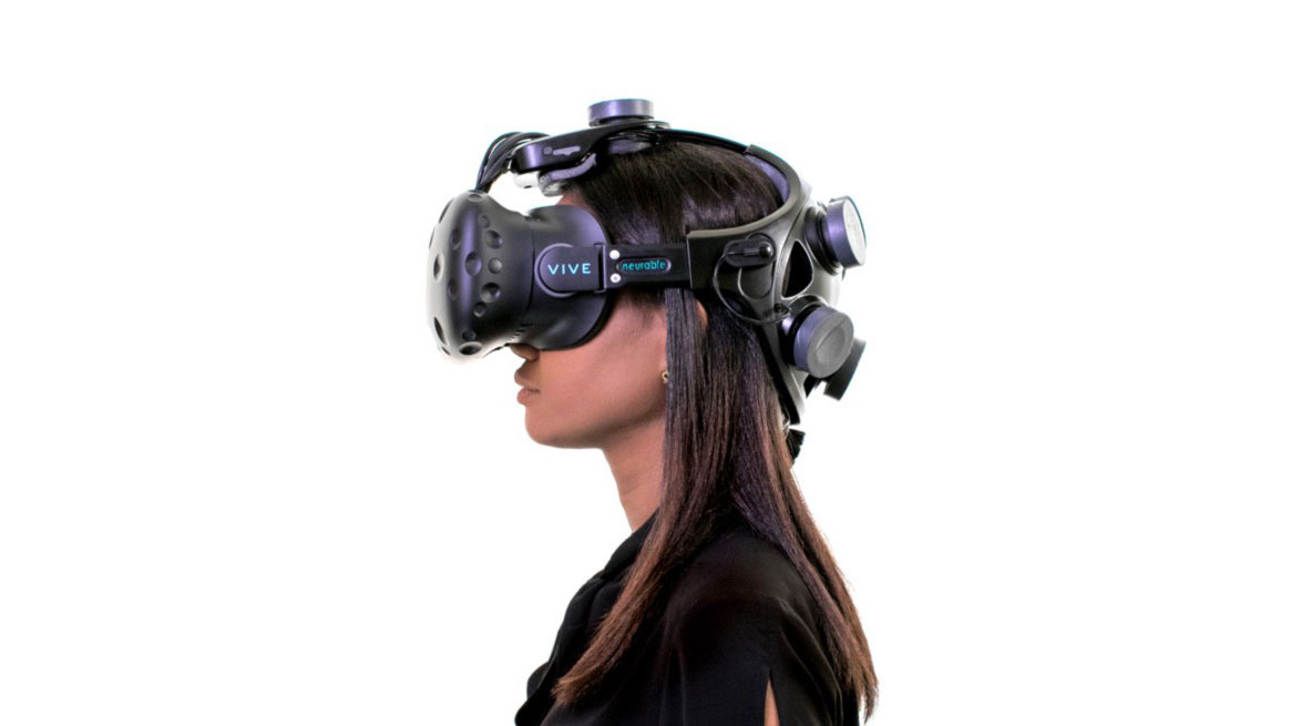 A woman wearing a Neurable VR headset on white background