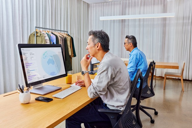 Man researching on a desktop computer.