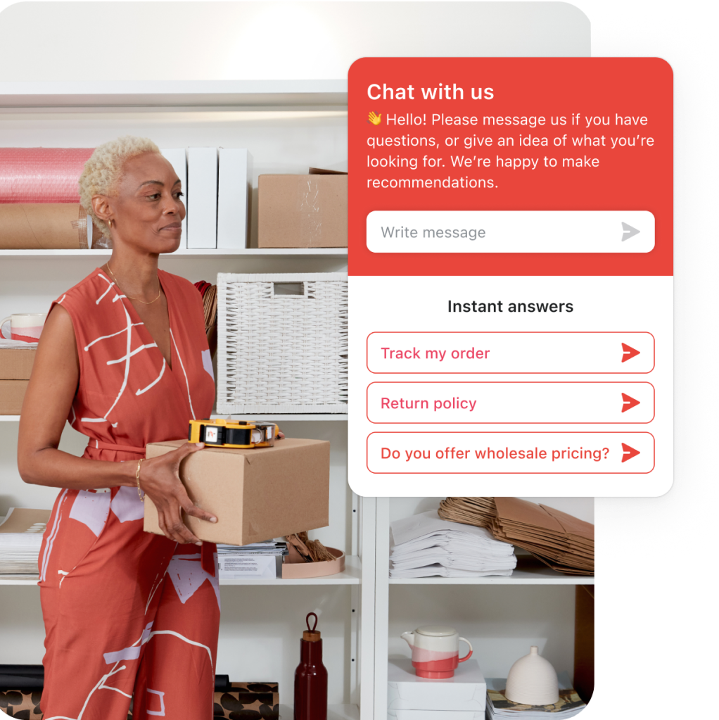 Business owner is standing in her back office carrying a box while doing inventory. Three instant answers are showing on screen, this feature of Shopify Inbox helps customers help themselves without the need for live chat.