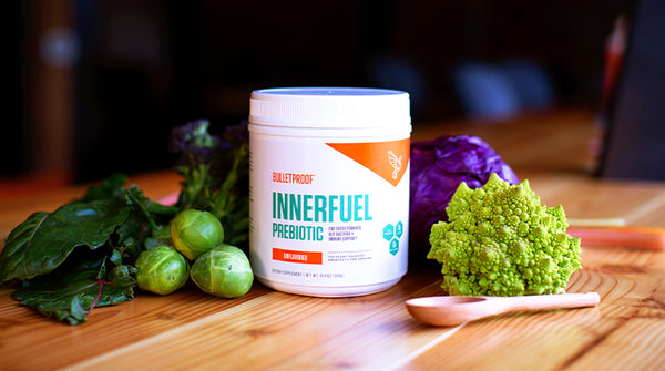 What are Probiotics? (A picture of Bulletproof InnerFuel next to hardy green vegetables)