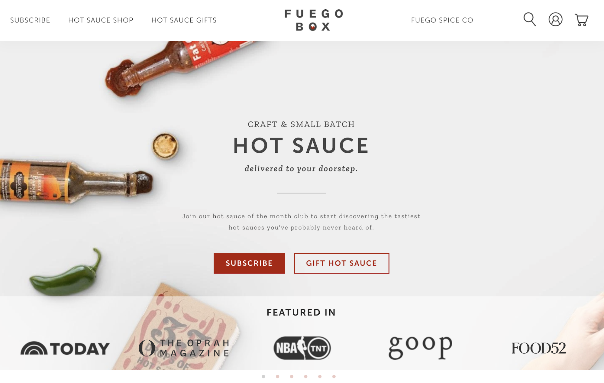 Fuego Box homepage with open bottles of hot sauce and a green chili