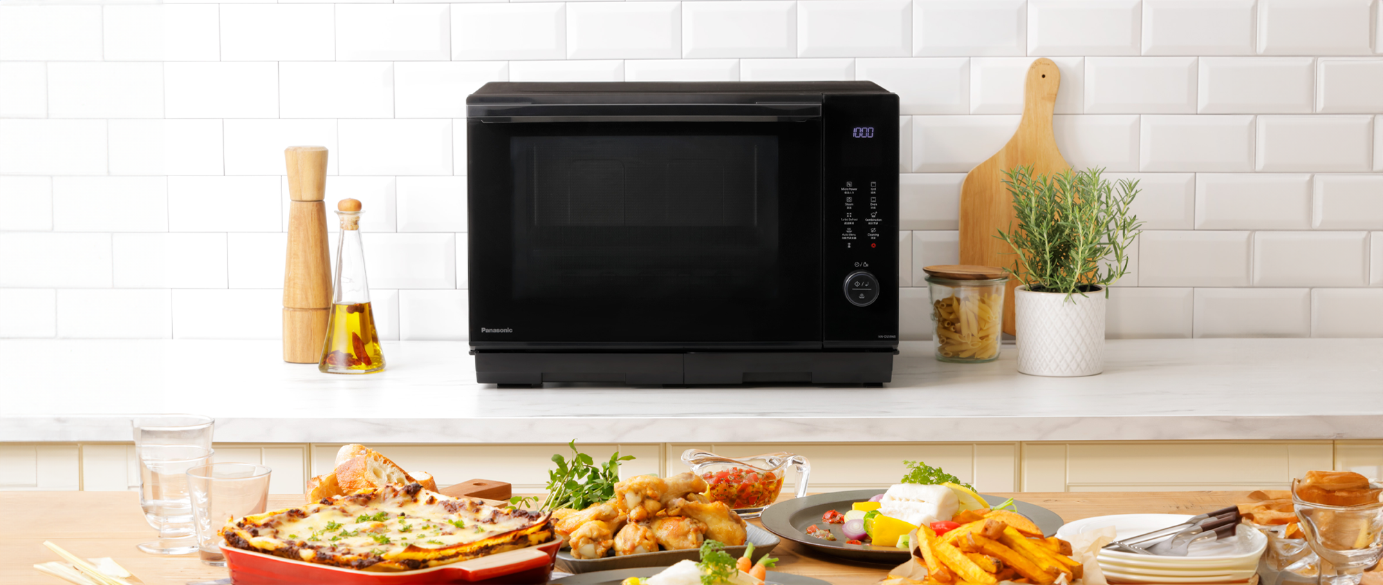 microwave oven on a kitchen table with a lot of grilled baked and steamed food