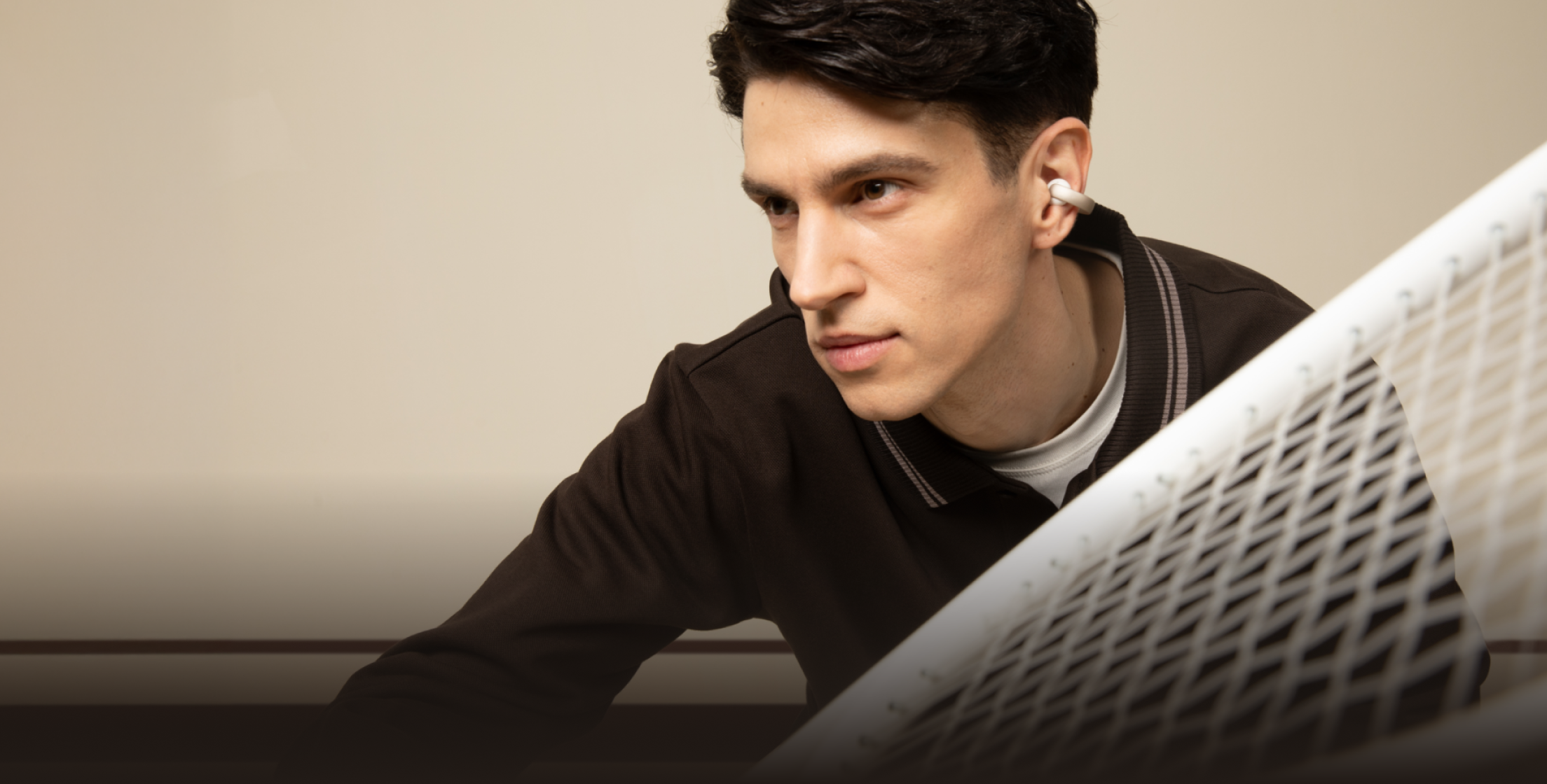 man wearing soundcore open earbuds while sports