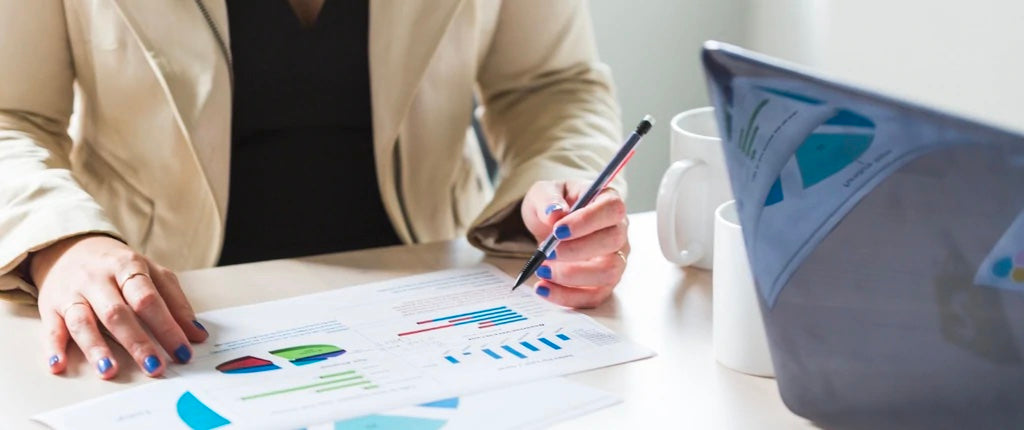 A person working on graphs at their desk