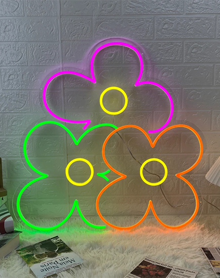 This custom neon sign shaped like a flower, featuring three vibrant colors: pink, green, and orange. This neon sign combines creativity and energy, making it a unique and eye-catching decor piece for any space. Ideal as a custom neon sign or decorative neon lights, it adds a lively and personalized touch to your environment.