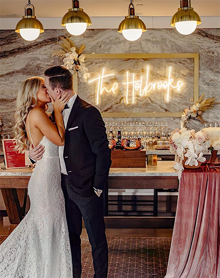 Our Customer celebrate her special day with this elegant and memorable custom neon wedding sign: 'The Holbrooks.' A perfect photo backdrop for her wedding venue, this white neon sign adds a touch of sophistication and warmth to her celebration.