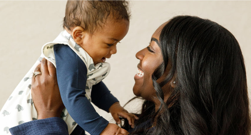 Mother holding up baby boy