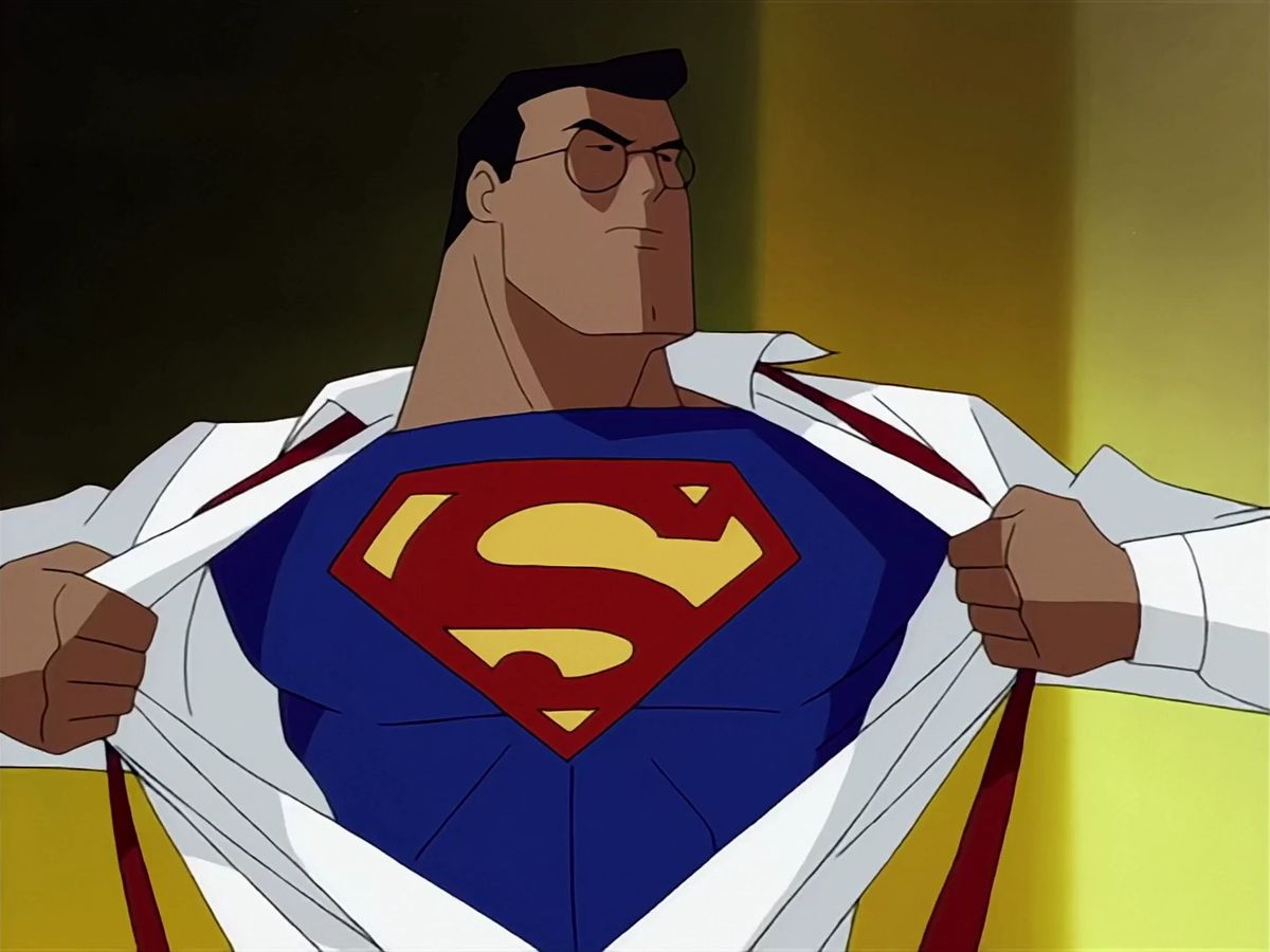 Clark Kent pulling open his dress shirt to reveal his Superman suit with the red and yellow ‘S’ emblem in Superman: The Animated Series.