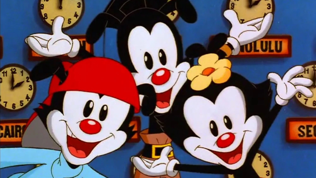 Yakko, Wakko, and Dot sign about time with clocks behind them in Animaniacs.