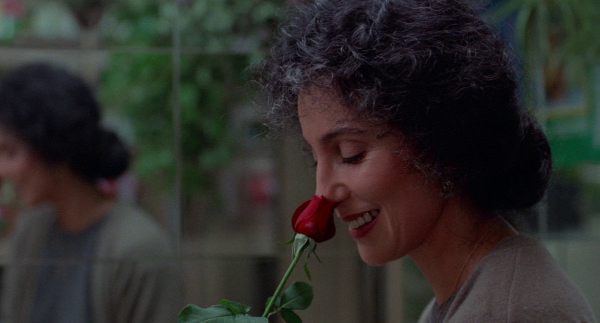Cher sniffs a rose in Moonstruck