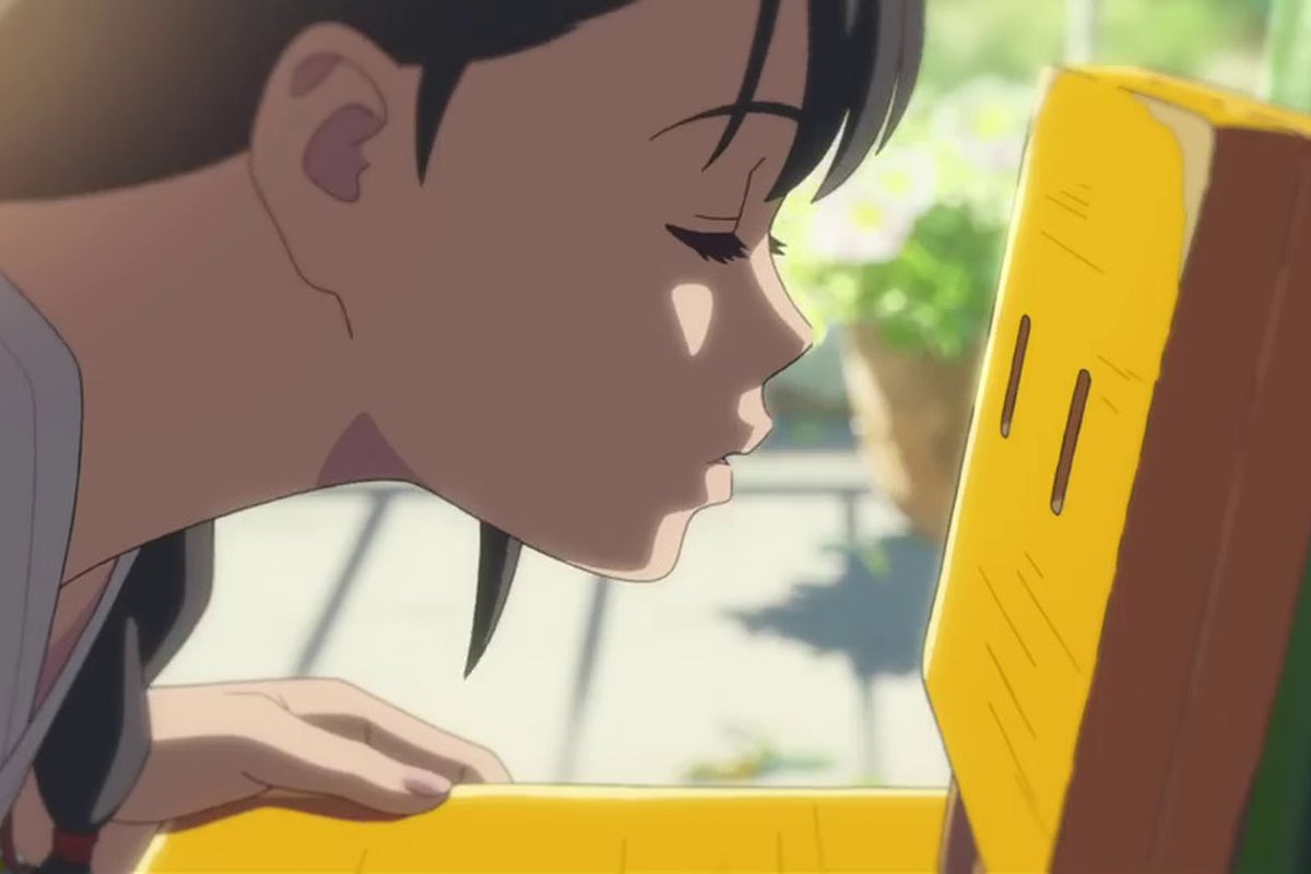 A close-up shot of an anime girl leaning in to kiss a wooden chair.