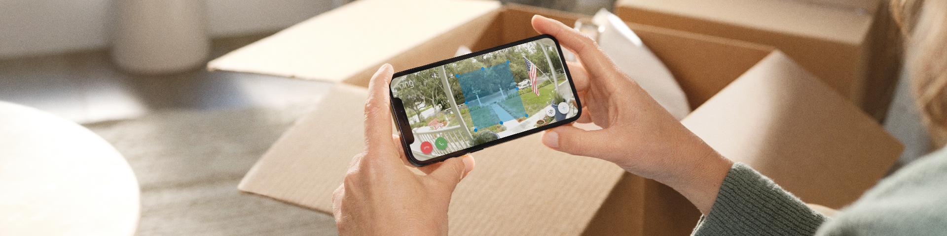 A homeowner using the Ring app and drawing motion zones of their front yard.