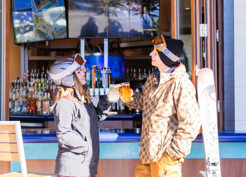 A Couple Of People In Front Of A Store Window