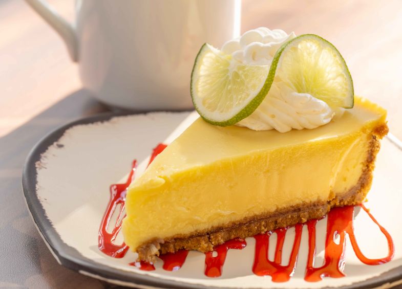 A Slice Of Cake With A Slice Of Lime On Top
