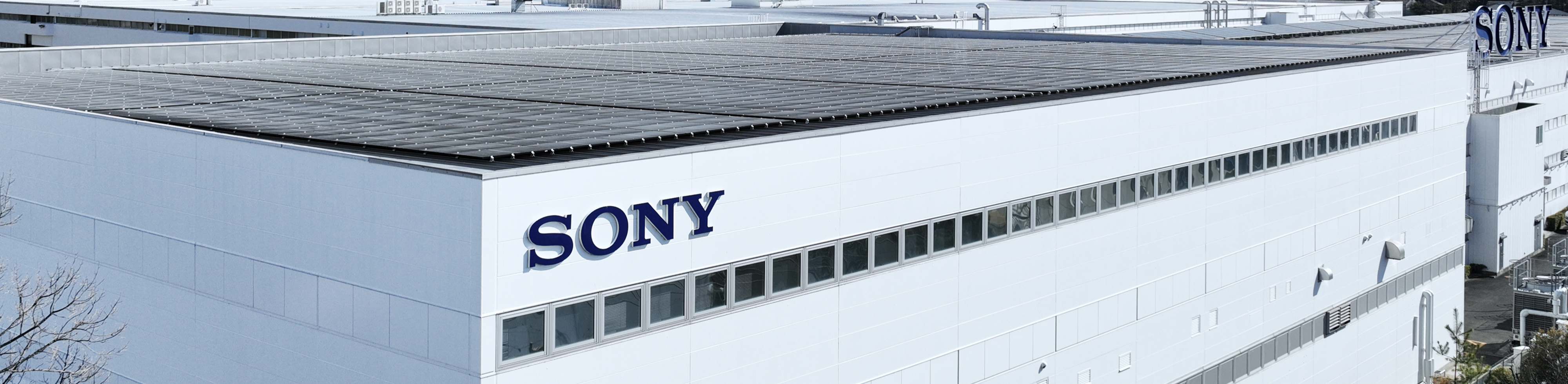 Photograph showing factory roof with solar panel and “SONY” logo