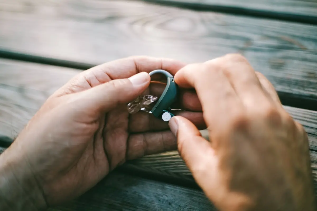 Hands holding hearing aids