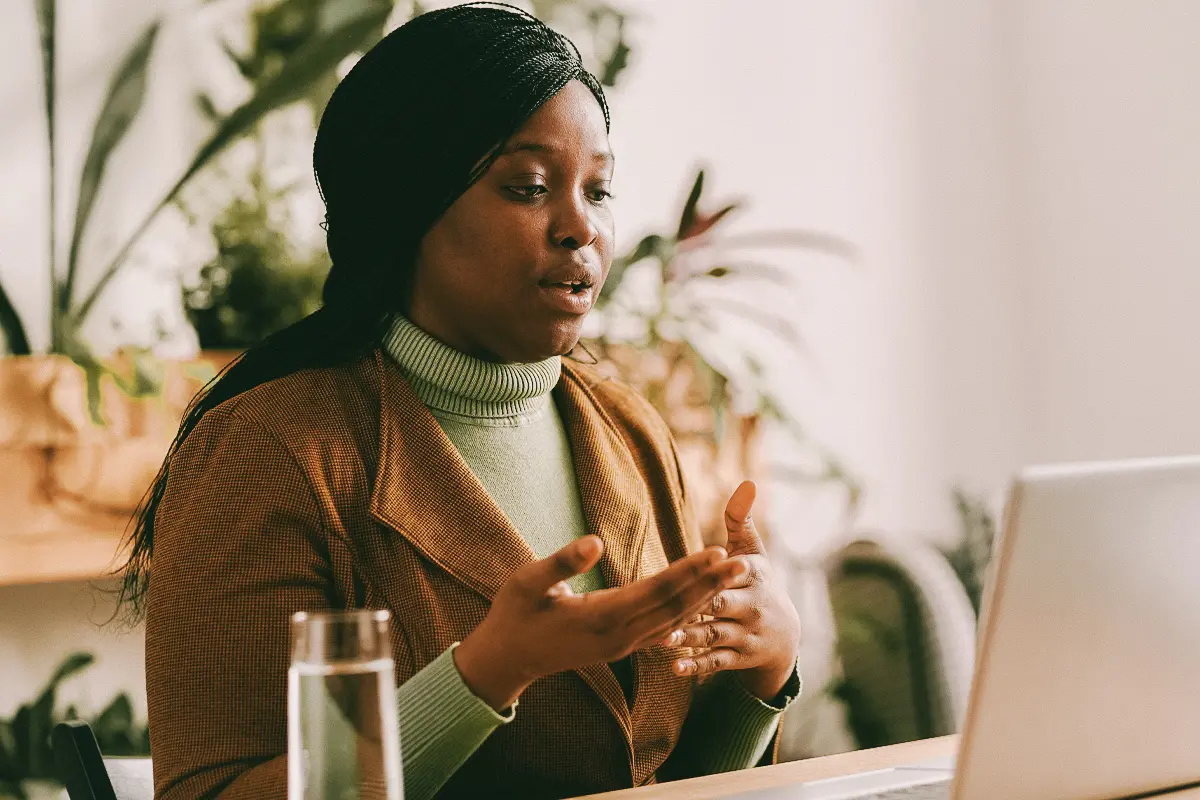 Young confident African American psychologist talking to online patient