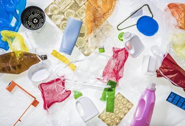 A photograph of different kinds of plastic waste, including bubble wrap, plastic bottles and shopping bags