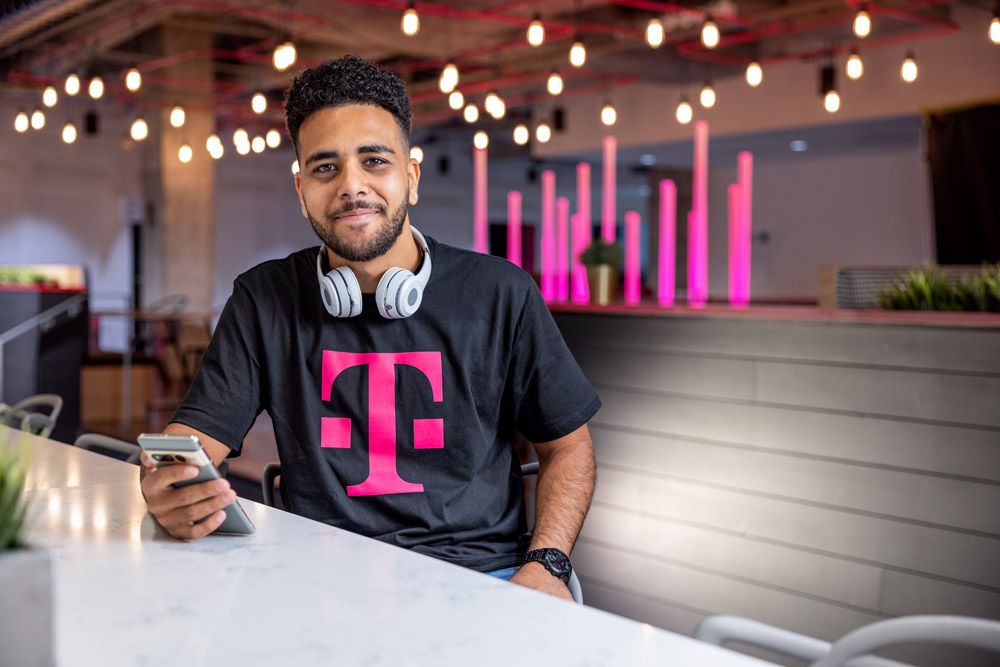 t-mobile employee sitting at table smiling